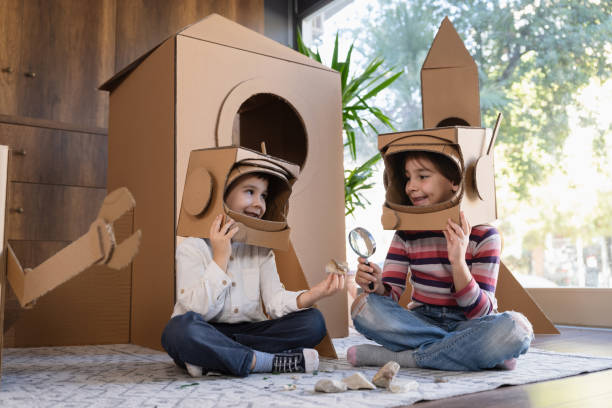 istock Children playing role play game as astronauts on mars. 1758146314