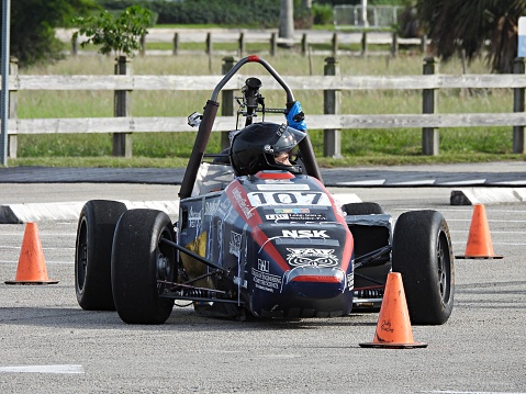 Solo racing in a parking lot.  Boca Raton, Palm Beach County, Florida, USA, October 22, 2023. This is a time trial event. A course is set up in the parking lot using orange traffic cones. The course has many turns, slaloms, chicanes, and other maneuvers to test a car and driver.