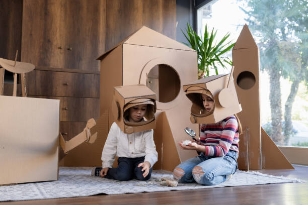 istock Children playing role play game as astronauts on mars. 1758164718
