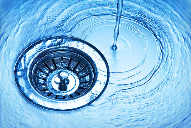 Kitchen sink Close-up of kitchen sink with water running away plumbing fixture stock pictures, royalty-free photos & images