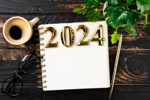 istock New year resolutions 2024 on desk. 2024 resolutions list with notebook, coffee cup on table. Goals, resolutions, plan, action, checklist concept. New Year 2024 template, copy space 1758172595