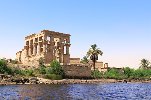 Temple of Isis on Agilkia Island (Philae) and the Greco-Roman buildings Trajan's Kiosk, reservoir of Aswan Low Dam, Egypt. View from Nile River