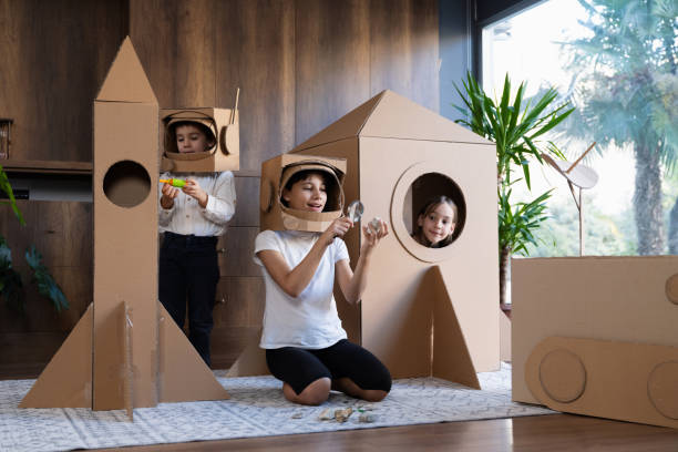 istock Children playing role play game as astronauts on mars. 1758190309