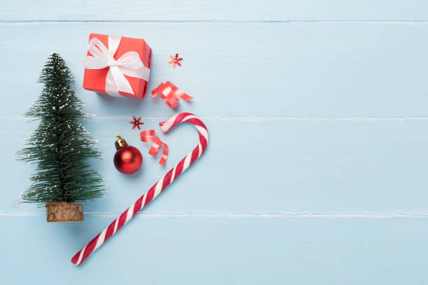 istock Miniature christmas tree with gift box and decor on wooden background 1758193203