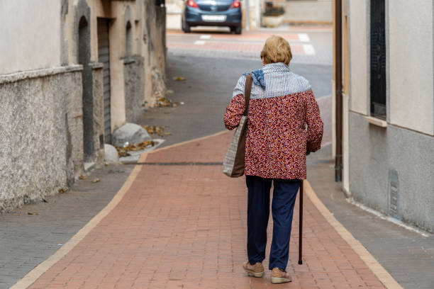 istock Granny walking by the old town. 1758195539