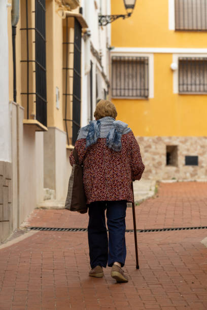 istock Granny walking by the old town. 1758195540
