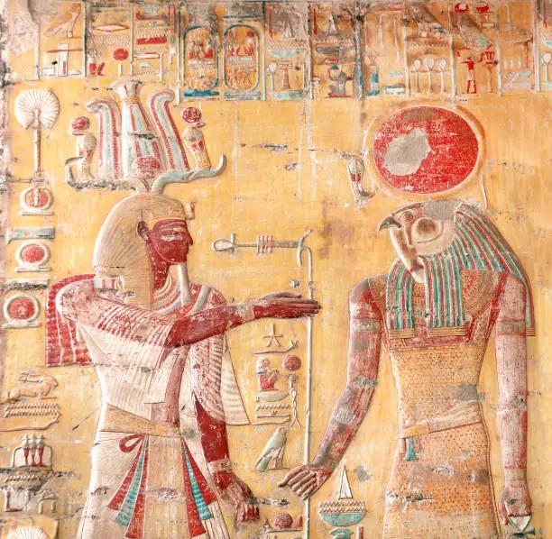 Ancient Colorful Mural Wall Painting inside Hatshepsut Temple in Valley of the Kings, Luxor, Egypt. Figure of the pharaoh and god Horus, wall of the Hatshepsut temple in Western Thebes