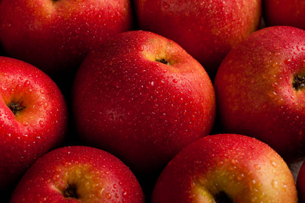 istock Red apples in water drops close-up, top vew 1758205449