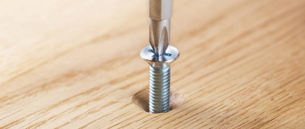 istock screwdriver screw in a wood oaks plank 1758229349