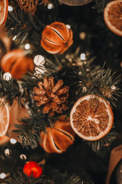 istock Winter decorations. Christmas tree decorated with dry oranges, mandarins and pine cones. 1758257923