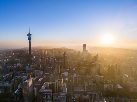 Hillbrow sunrise urban residential area with many skyscraper apartment blocks in Johannesburg city, showing the prominent Telkom tower and Ponte City apartments.
