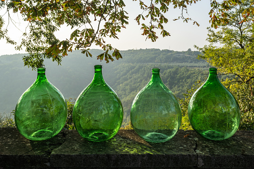 Four green glass jugs at the flea market