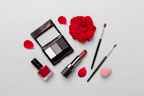 istock Flat lay with makeup products and tools with flowers on color background 1758274822
