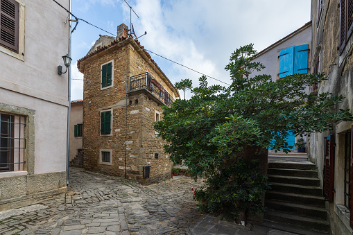 Beautiful street scene with ancient houses in Groznjan town on a sunny day, Croatia.