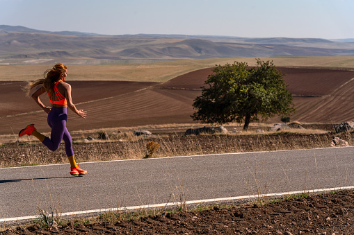 Healthy Lifestyle: Family Picnic and Exercise. Woman Athlete Running.