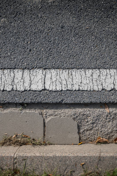 istock Aerial Close-up: White Road Markings and Shoulder Pavers on Asphalt Road 1758296049
