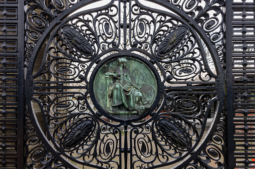 The Hague, Netherlands - April 17, 2023: Figure of Peace (Pax) on the black wrought iron gates of the Peace Palace in The Hague, which houses the International Court of Justice