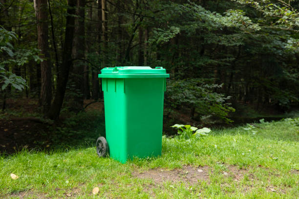 istock green plastic trash can in a forest park. 1758307930
