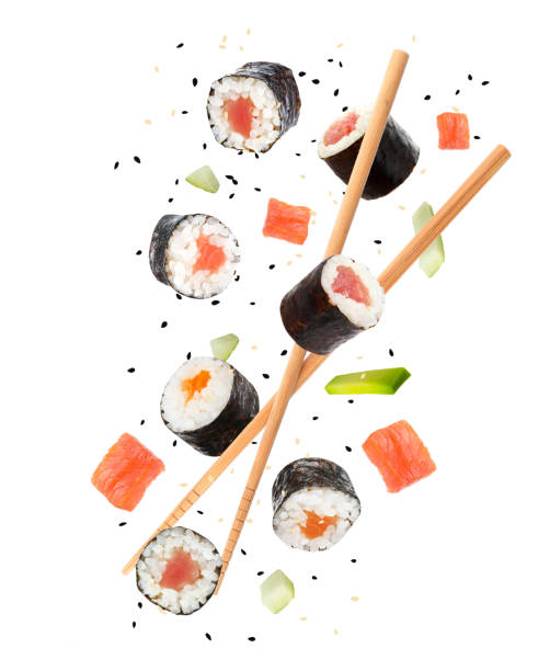 istock Sushi rolls and wooden chopsticks flying on white background 1758317699