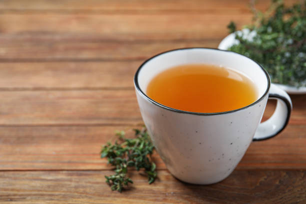 istock Aromatic herbal tea with thyme on wooden table, closeup. Space for text 1758318699