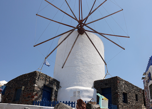 Traditional white windmill in Oia on the island of Santorini. Cyclades, Greece