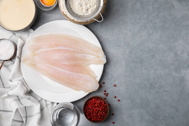 istock Different ingredients for soda water batter and raw fish fillet on grey table, flat lay. Space for text 1758319763