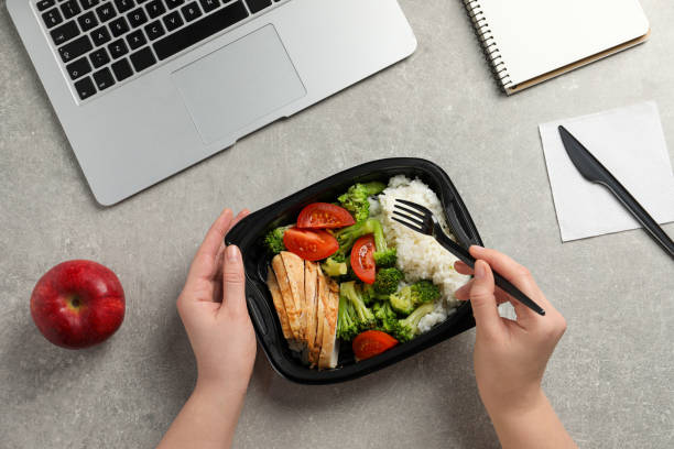 istock Office employee having business lunch at workplace, top view 1758329040