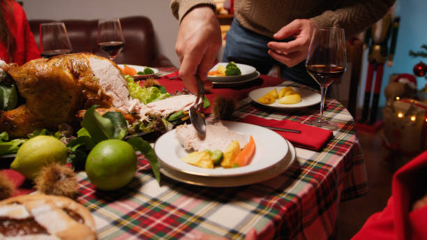 istock Man preparing and serving roasted turkey for thanksgiving 1758331781