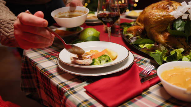 istock Man serving turkey with sauce for thanksgiving dinner 1758332465