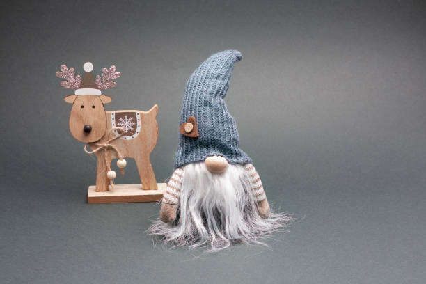 istock Elf in grey hat with reindeer, green background. 1758335556