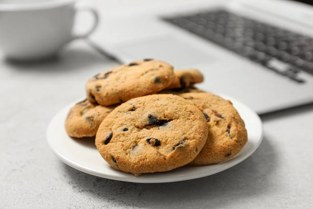 istock Chocolate chip cookies on light gray table in office, closeup 1758341594