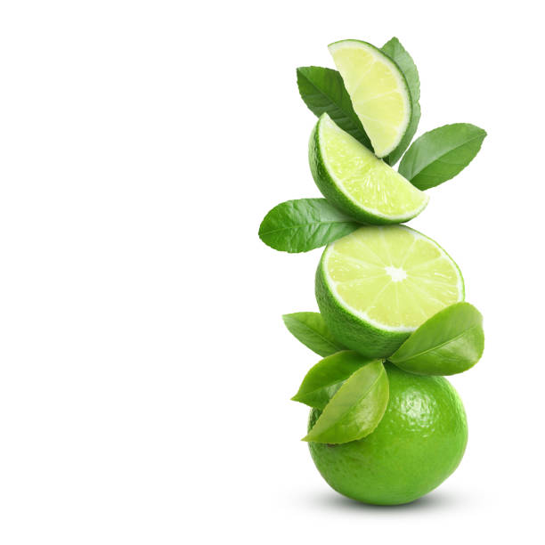 istock Stacked cut and whole limes with gren leaves on white background 1758342176