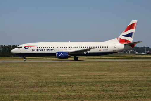 A passenger jet taxis towards an airport gate after landing.