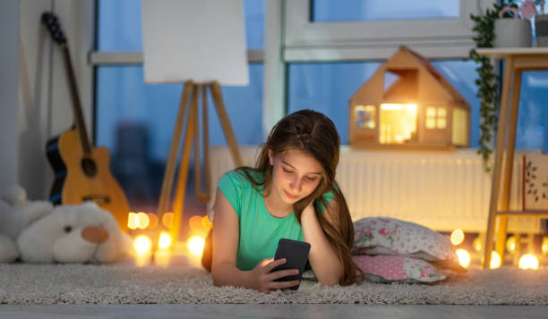 istock Young girl on floor with smart phone 1758354839