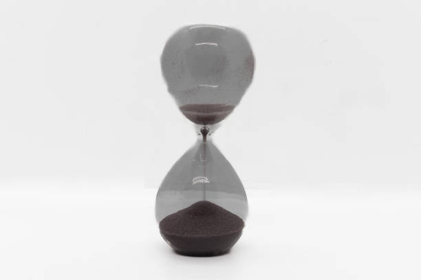 istock Hourglass running out of time isolated on white 1758363216