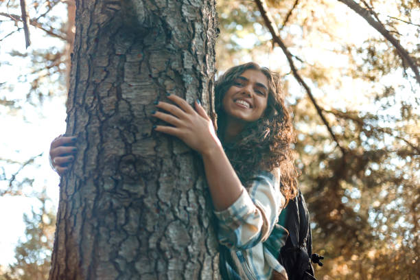 istock Young woman hugs tree in mountain setting 1758365346