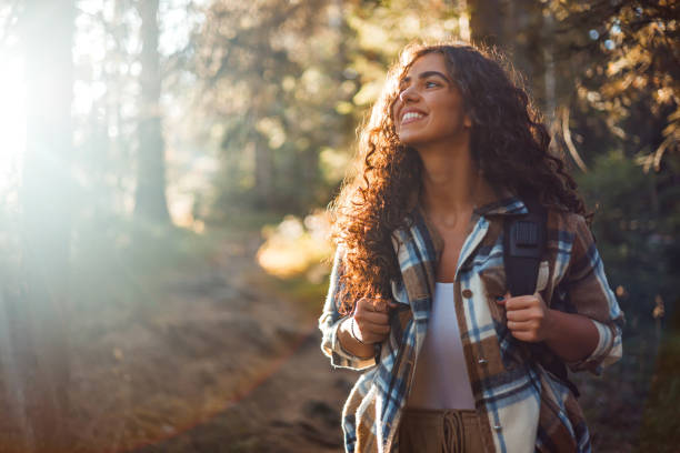 istock Joyful woman traverses mountain with backpack 1758365858