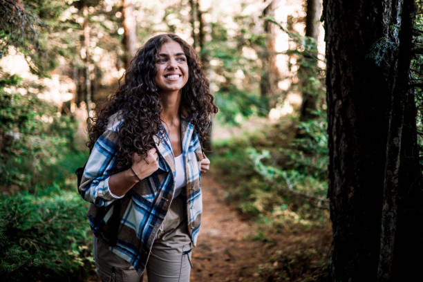 istock Smiling young woman tackles mountain hike 1758365869