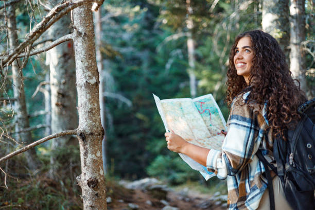 istock Young woman's mountain trek guided by map 1758365870