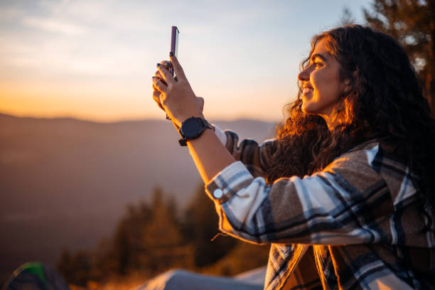 istock Woman documents scenic landscape with phone 1758369604