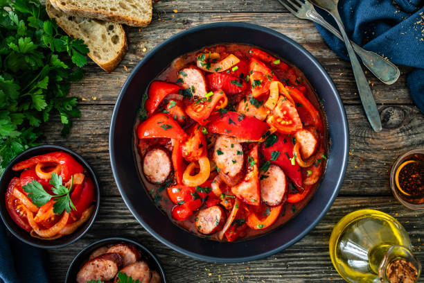 istock Hungarian stew - vegetables with sausages on wooden table 1758372307