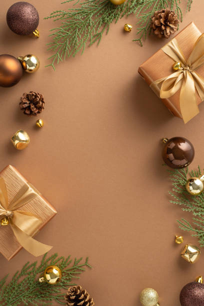 istock Vertical top view elegant holiday arrangements featuring opulent gift boxes, baubles, delicate jingle bells, spruce twigs with cones on brown backdrop. Perfect for festive greetings and advertisements 1758398724