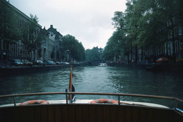 Amsterdam canal viewed from boat on an overcast day- photographed in October 1986, vintage slide film scan.