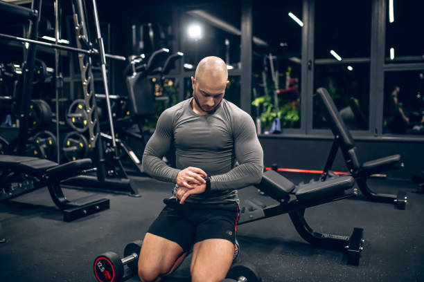 istock Sport man checking workout result on smartwatch app after exercise session in gym. 1758406923