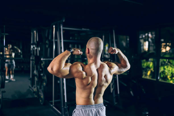 istock Muscular bodybuilder flexing in front of mirror 1758414657