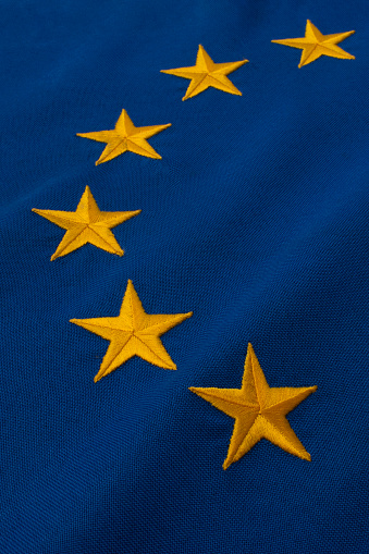 European flag.Twelve golden stars in a circle on a blue background.\nEach star is individually embroidered.