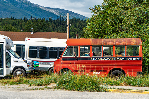 Skagway, Alaska - Aug. 5, 2023: Skagway Float Tours bus parked at the parking lot.  Skagway townscape in the morning, Alaska, USA.