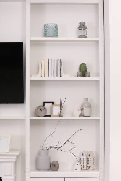 istock Stylish shelves with different decor elements in room. Interior design 1758451098