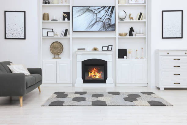 istock Stylish room with beautiful fireplace and comfortable sofa. Interior design 1758451104