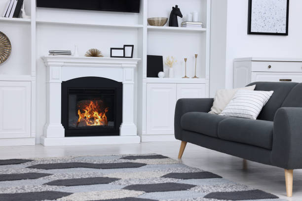 istock Stylish room with beautiful fireplace and comfortable sofa. Interior design 1758451131